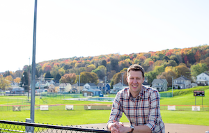 Picture of Josh with fall trees in the background